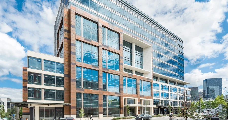 Street view of a modern life sciences building with large reflective windows