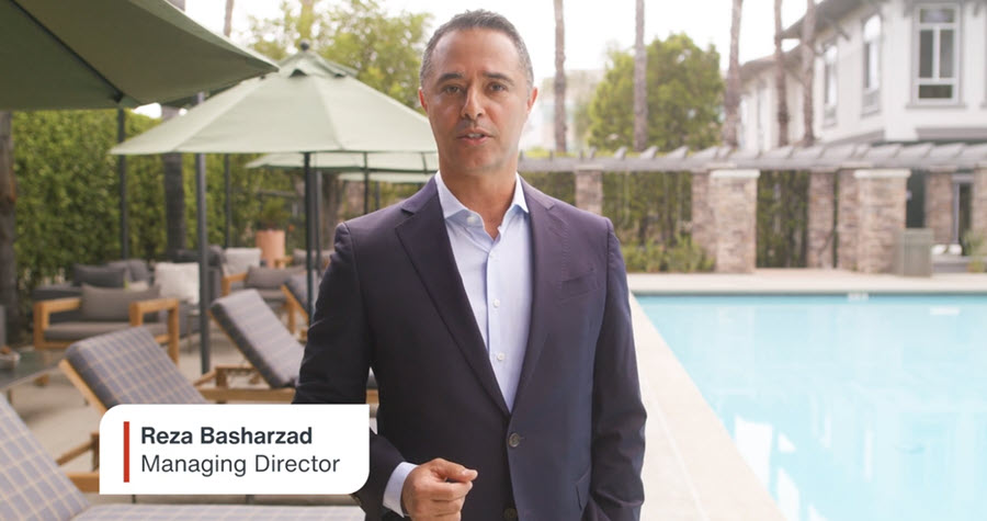 Man speaking in front of a residential swimming pool