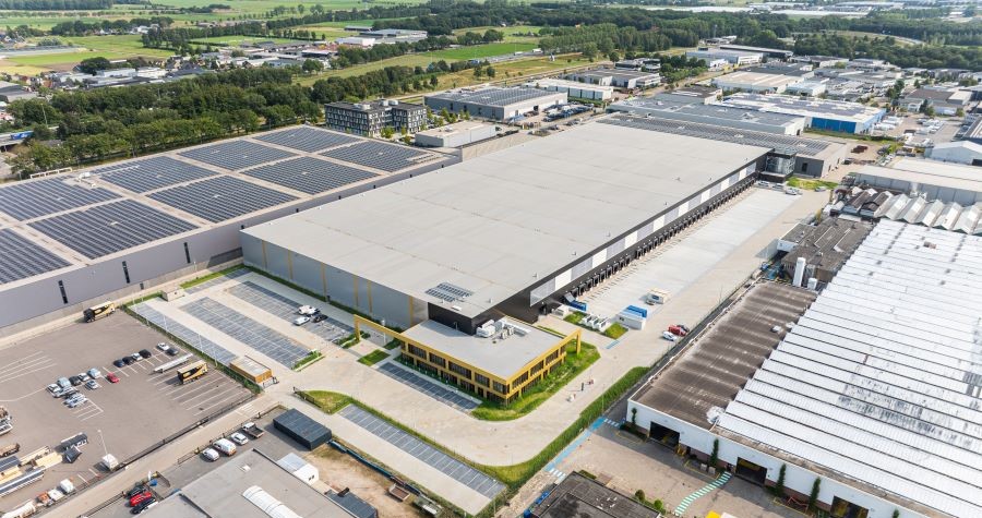 Aerial view of vast industrial complex with a multi-story office and large parking lot