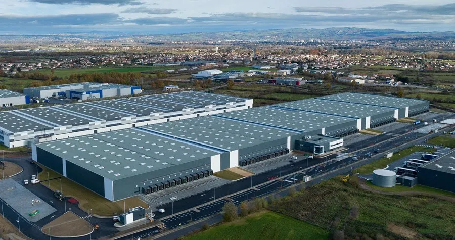 Aerial view of vast industrial complex with landscape in the background