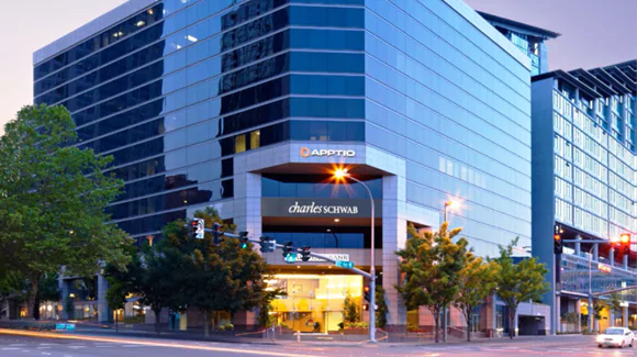 Exterior of an office building at the corner of a busy intersection